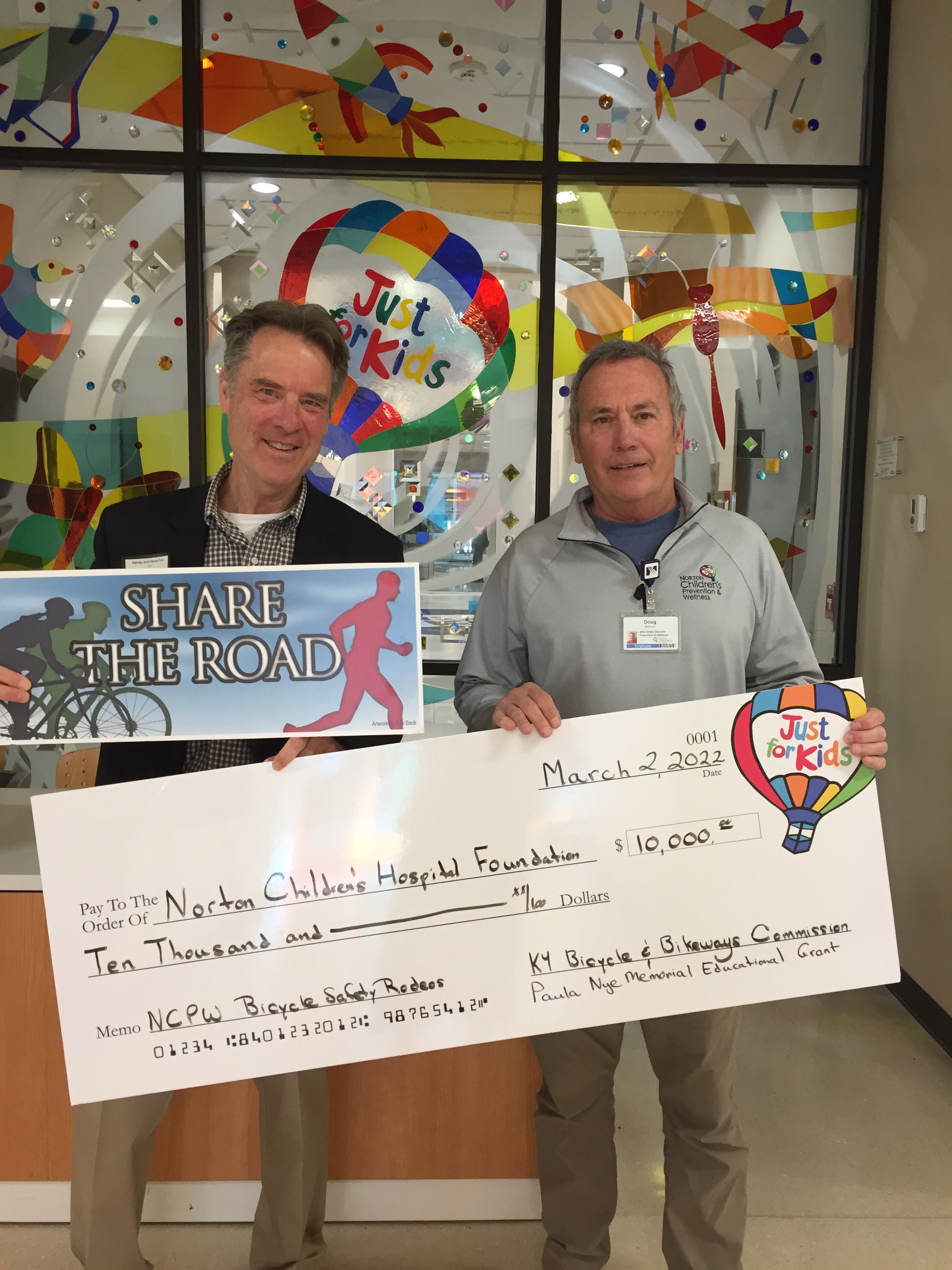 Commissioner Robert Clifford presents a check to Norton Children's Hospital