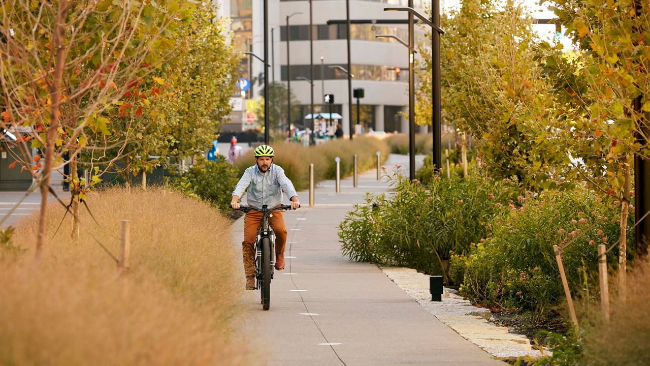 A cyclist on the Town Branch Trail in downtown Lexington