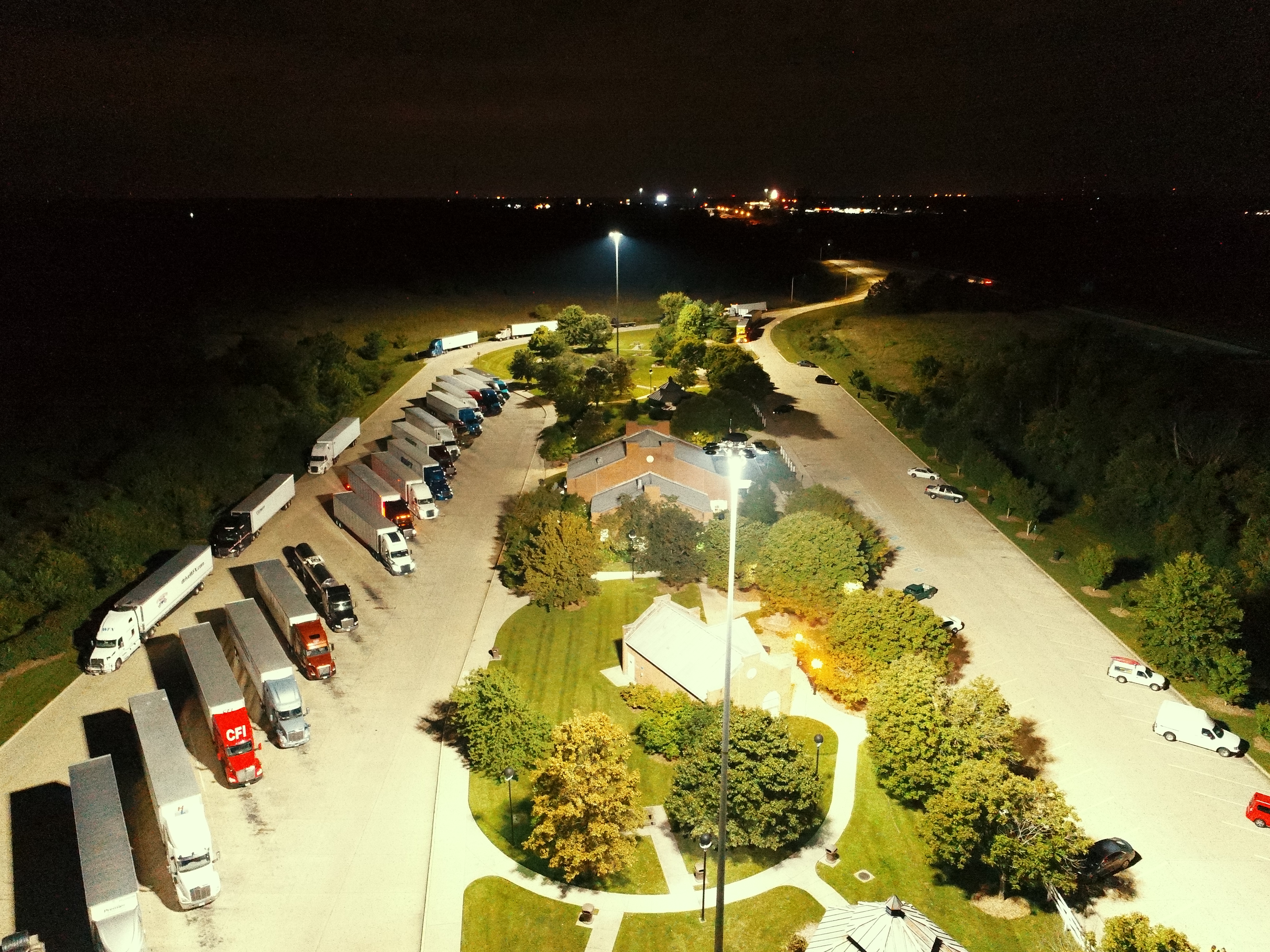 A rest area in Kentucky with a full lot of semi trucks parked for the evening