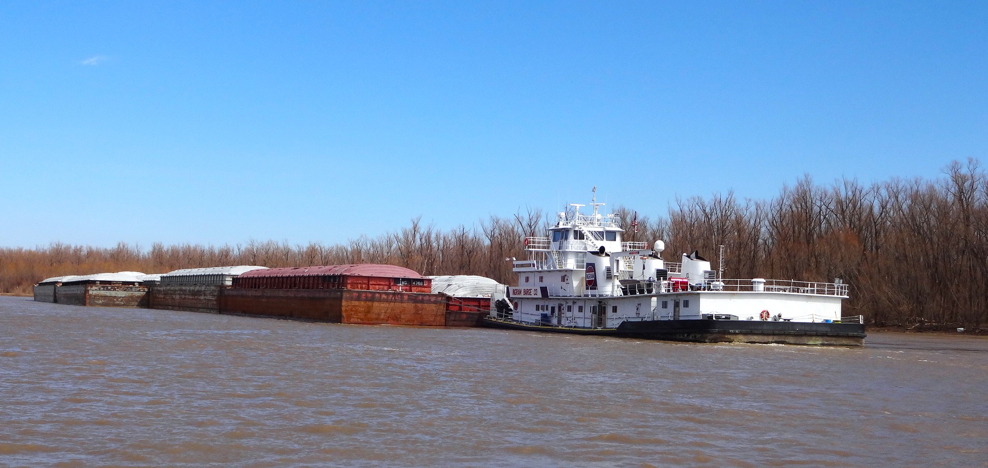 A tug boat hauling container on barge cargo on one of Kentucky's commercially navigable waterways.